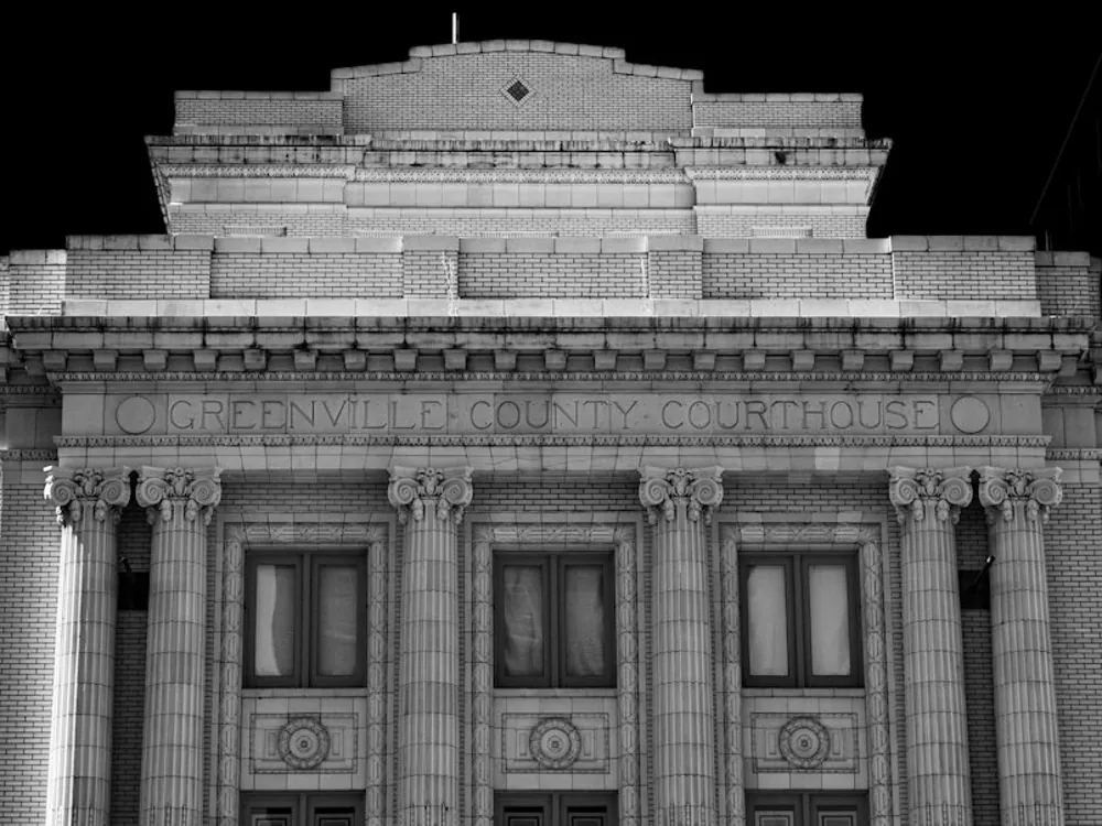 Fachada com colunas de um edifício institucional, em preto e branco